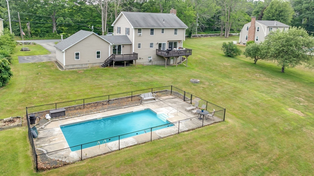157 Podunk Road Sturbridge, MA 01566 - Photo 33 of 42 a view of a house with a yard patio and sitting area