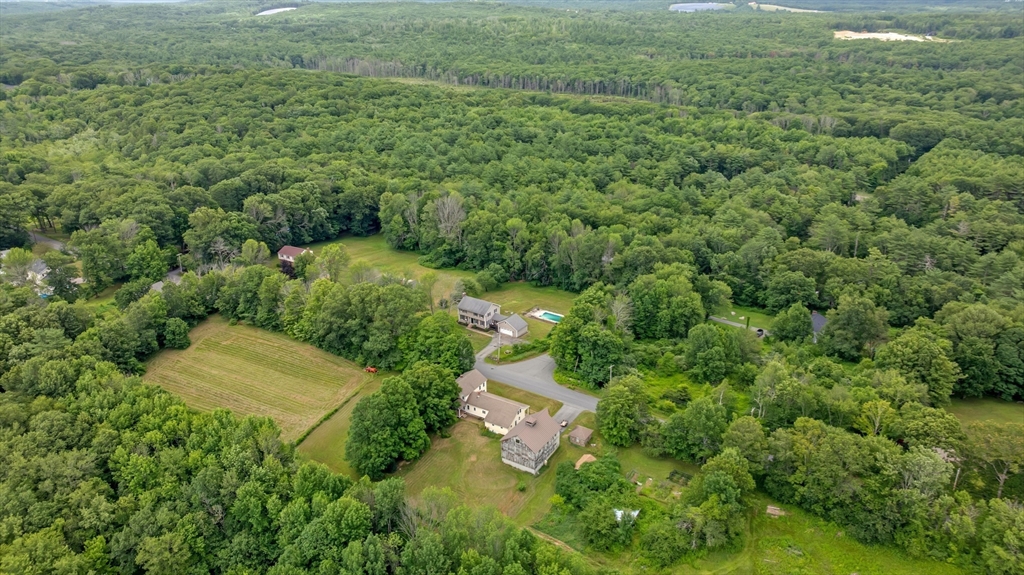 157 Podunk Road Sturbridge, MA 01566 - Photo 38 of 42 an aerial view of residential house with outdoor space and trees all around