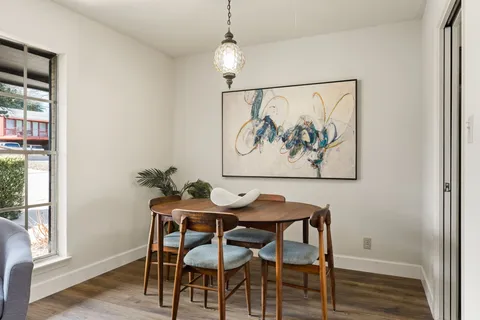 a dining room with furniture and wooden floor