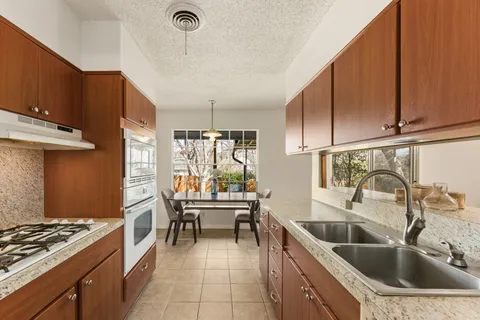 a kitchen with a sink and a stove top oven