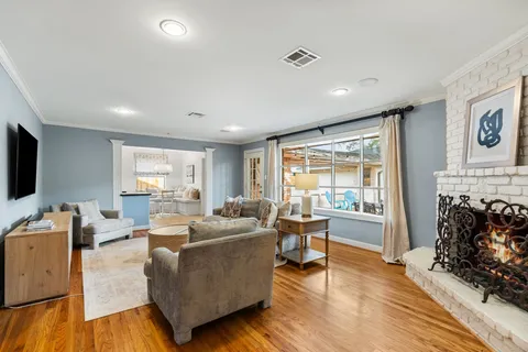 a living room with fireplace furniture and a flat screen tv
