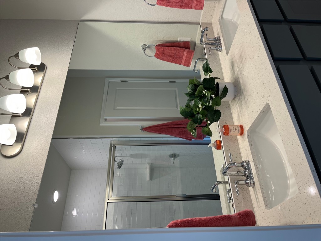 130 Spangle Way Kyle, TX 78640 - Photo 12 of 28 a bathroom with a sink and a mirror