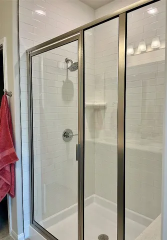 a bathroom with a glass shower door