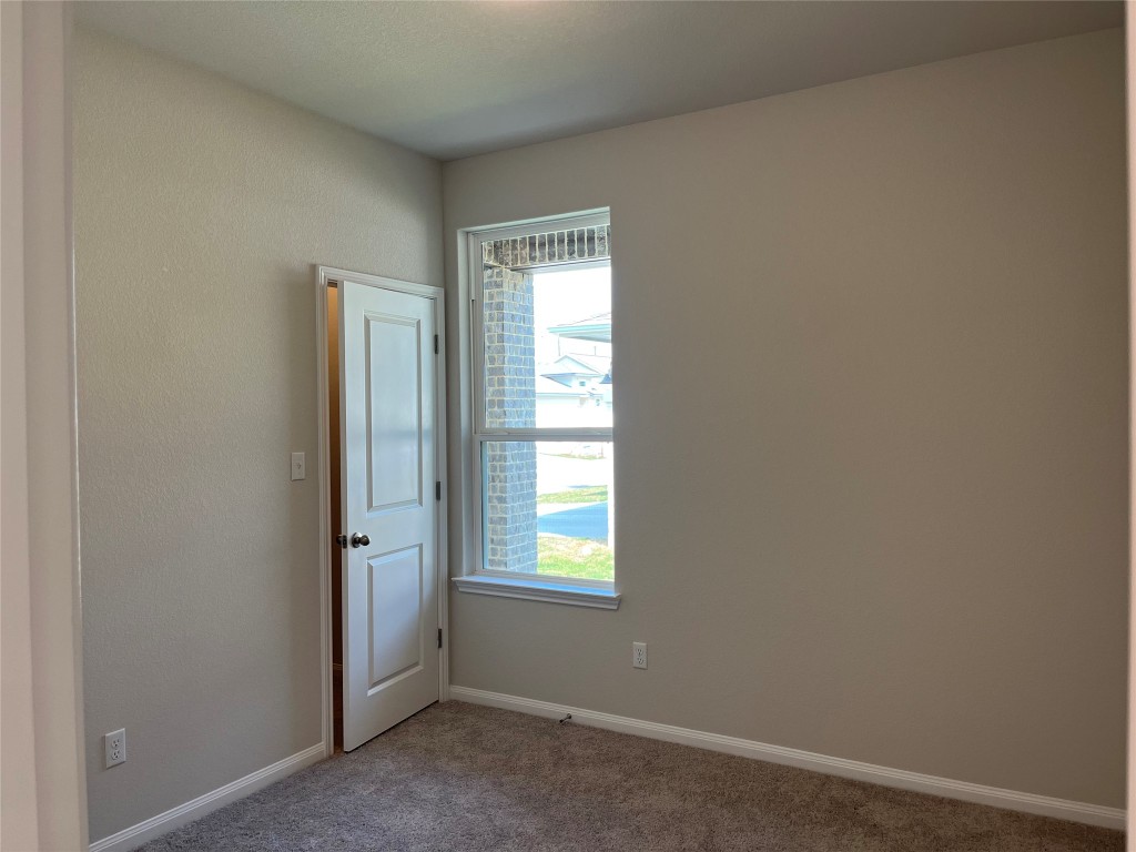 130 Spangle Way Kyle, TX 78640 - Photo 17 of 28 an empty room with windows and closet