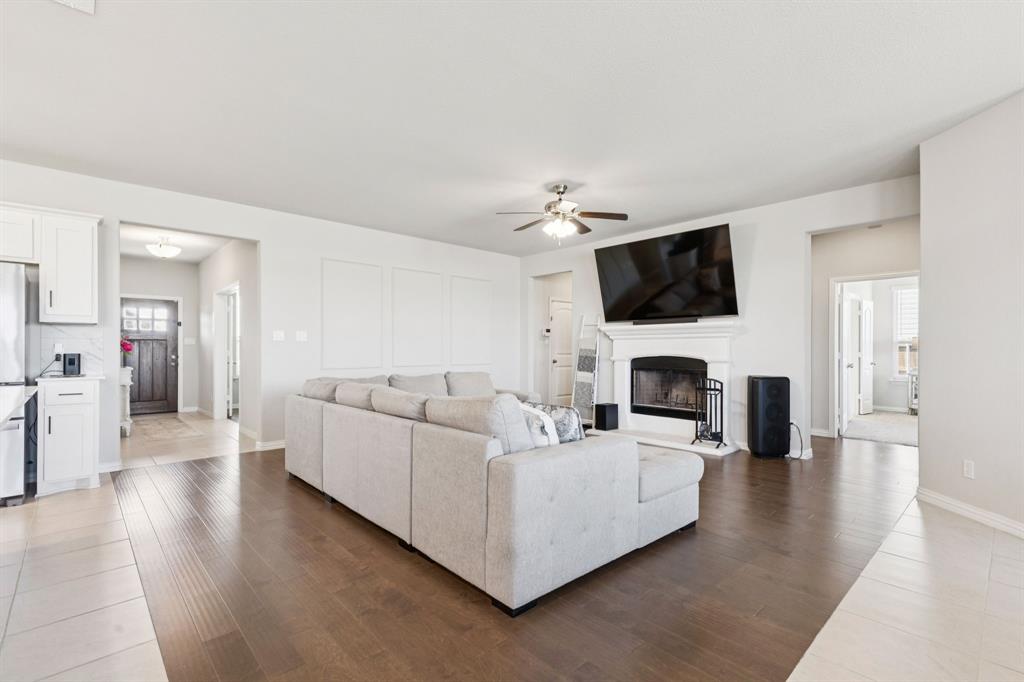 118 Mossy Creek Trail Rhome, TX 76078 - Photo 11 of 28 a living room with furniture a flat screen tv and a fireplace