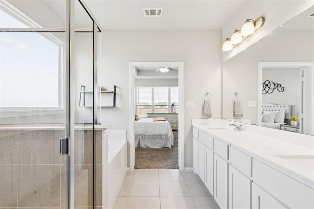 118 Mossy Creek Trail Rhome, TX 76078 - Photo 22 of 28 a bathroom with a double vanity sink mirror and shower