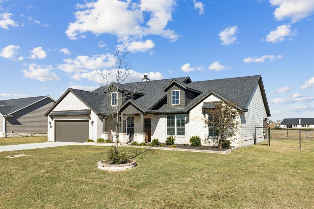 118 Mossy Creek Trail Rhome, TX 76078 - Photo 28 of 28 a front view of a house with a yard
