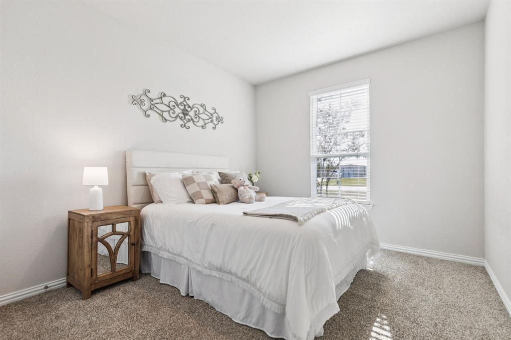 118 Mossy Creek Trail Rhome, TX 76078 - Photo 7 of 28 a bedroom with a bed and a window