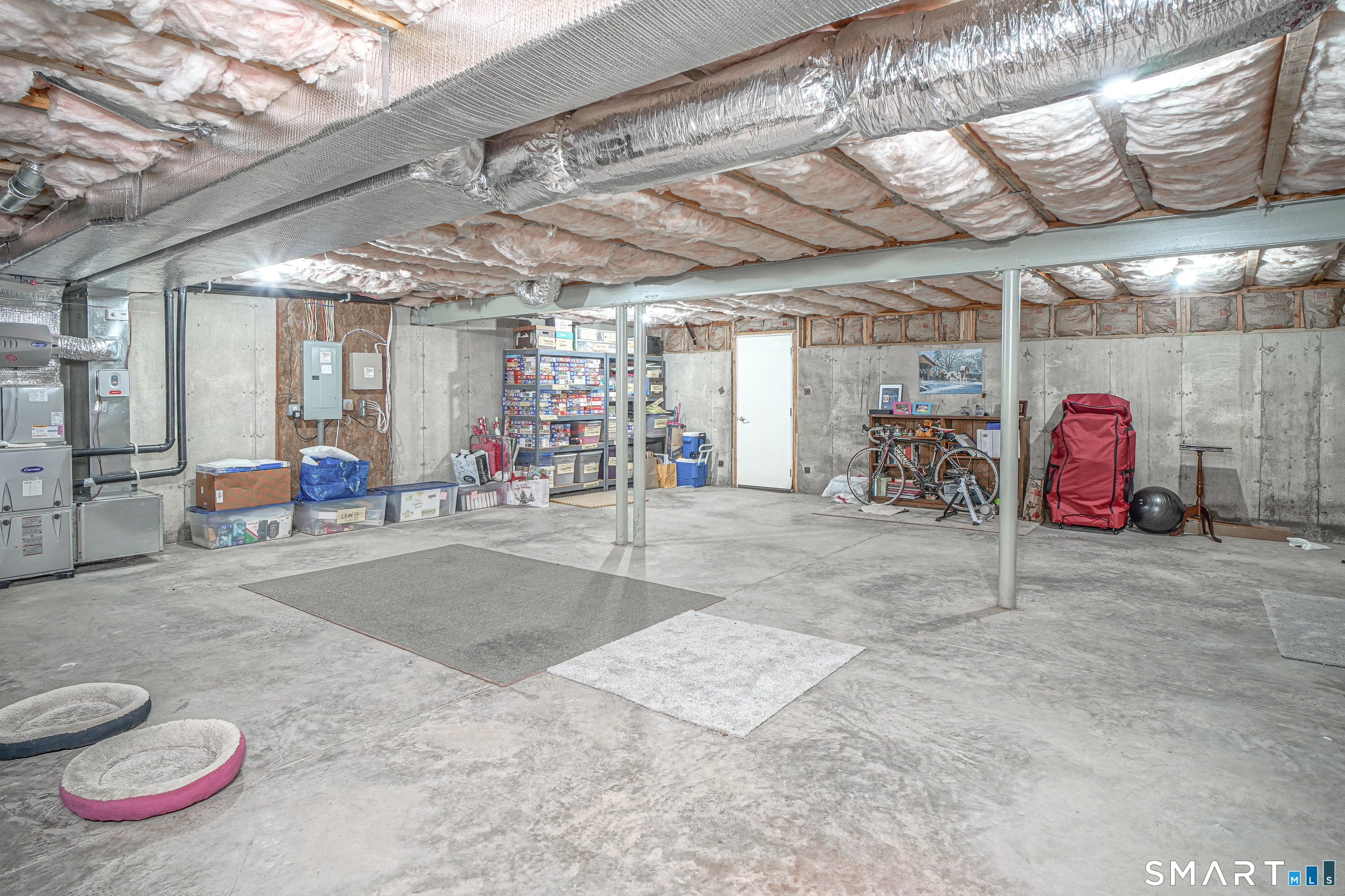 6 Lilac Lane, Unit 6 Prospect, CT 06712 - Photo 29 of 40 The spacious basement with walk-out access through the belco doors makes it easy to bring in deck furniture or any additional items that need to be stored. Steal beam construction.