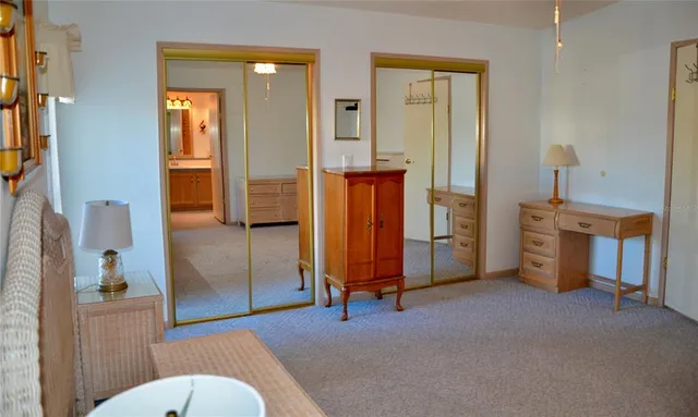 a view of an empty room with glass door and furniture