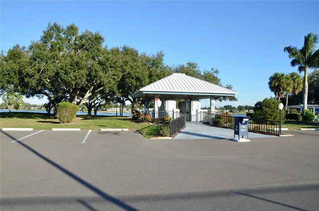 a view of patio with table and chairs under an umbrella