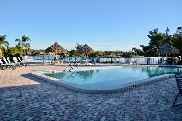 a view of a swimming pool with an outdoor seating