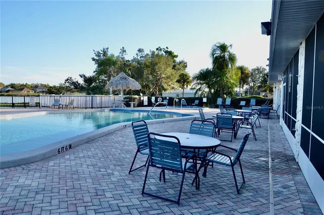 a view of a street with a building and trees in the background