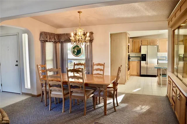 a view of a dining room with furniture and chandelier