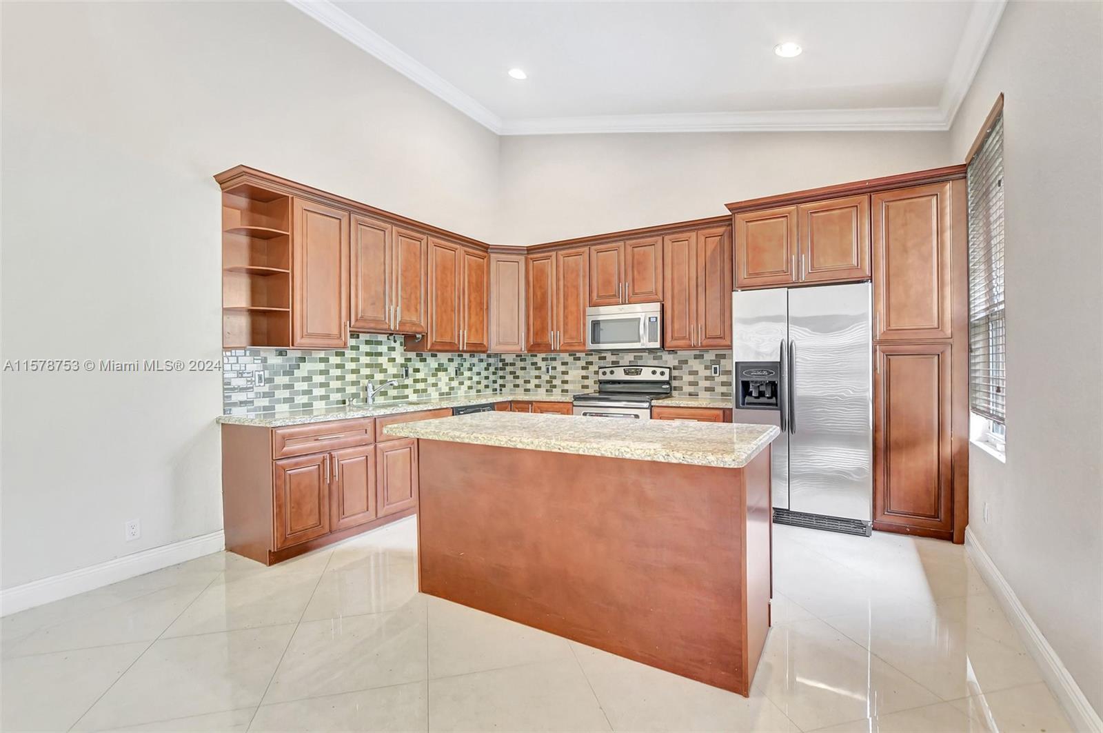 20916 Avenel Run Boca Raton, FL 33428 - Photo 14 of 43 a kitchen with stainless steel appliances granite countertop a refrigerator sink and cabinets