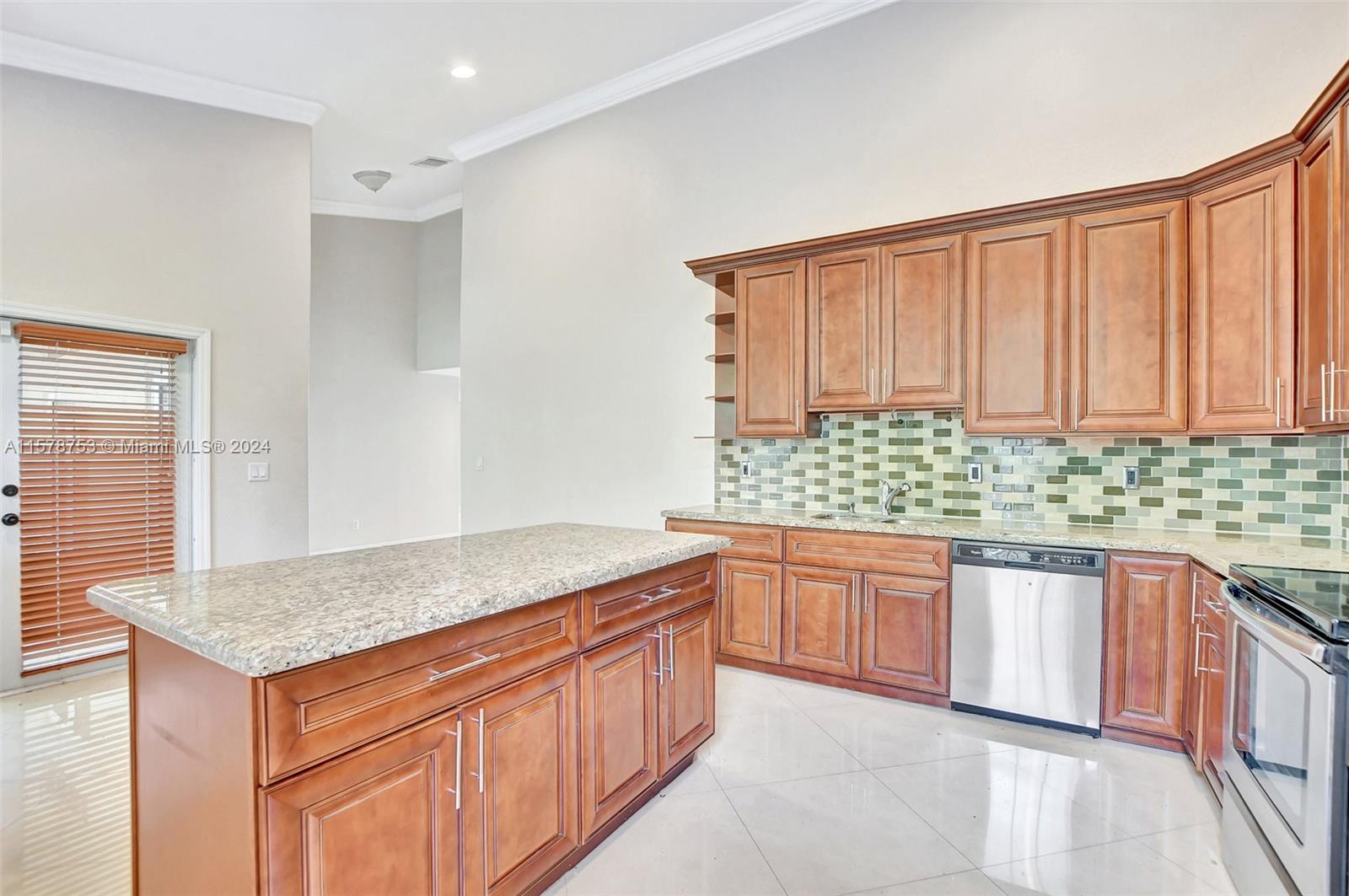 20916 Avenel Run Boca Raton, FL 33428 - Photo 16 of 43 a kitchen that has a sink and a wooden cabinets