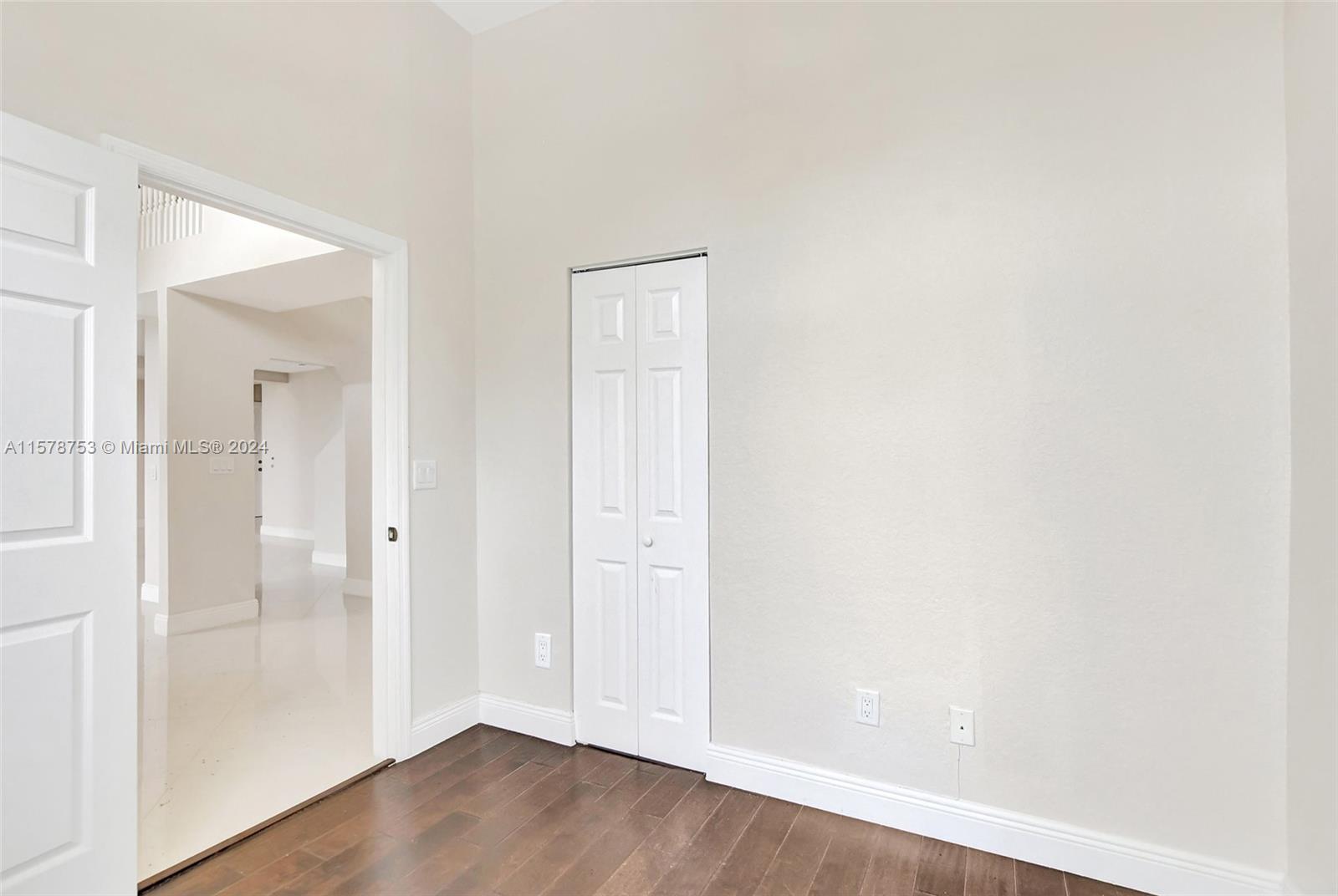 20916 Avenel Run Boca Raton, FL 33428 - Photo 21 of 43 an empty room with wooden floor and mirror