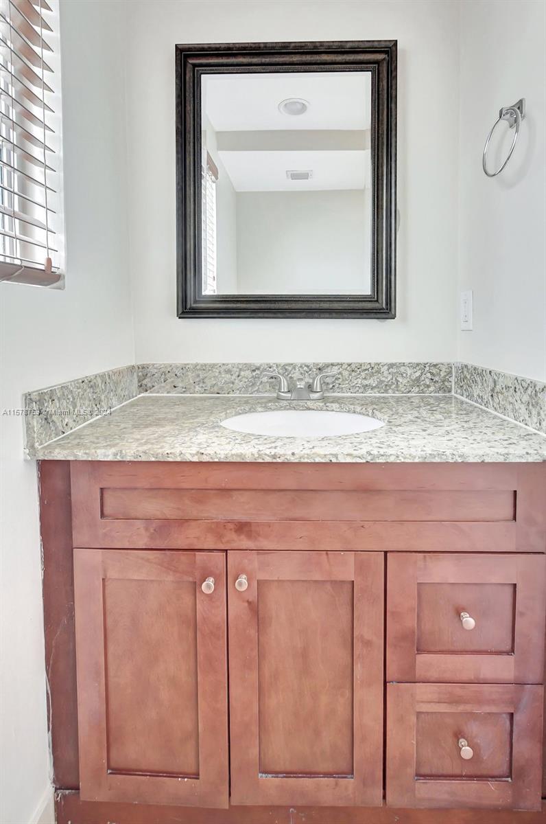 20916 Avenel Run Boca Raton, FL 33428 - Photo 22 of 43 a bathroom with a sink and a mirror