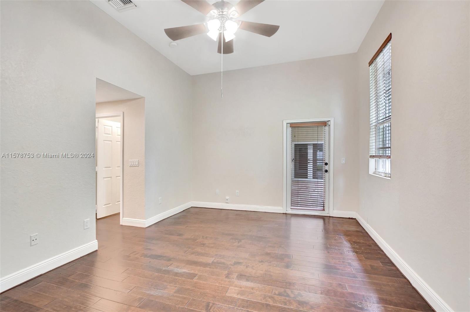 20916 Avenel Run Boca Raton, FL 33428 - Photo 24 of 43 an empty room with wooden floor and windows