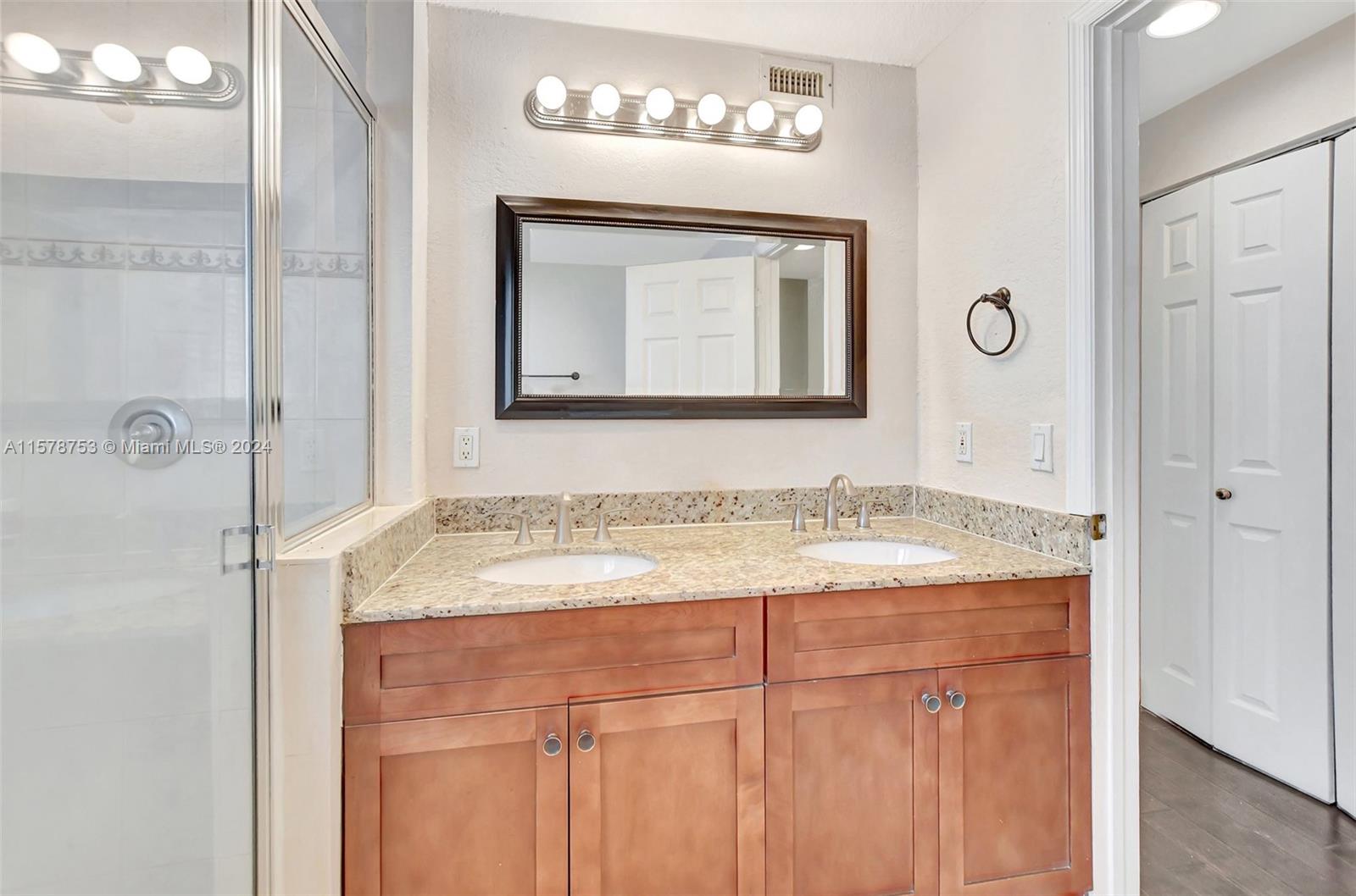20916 Avenel Run Boca Raton, FL 33428 - Photo 28 of 43 a bathroom with a granite countertop sink a mirror and a shower