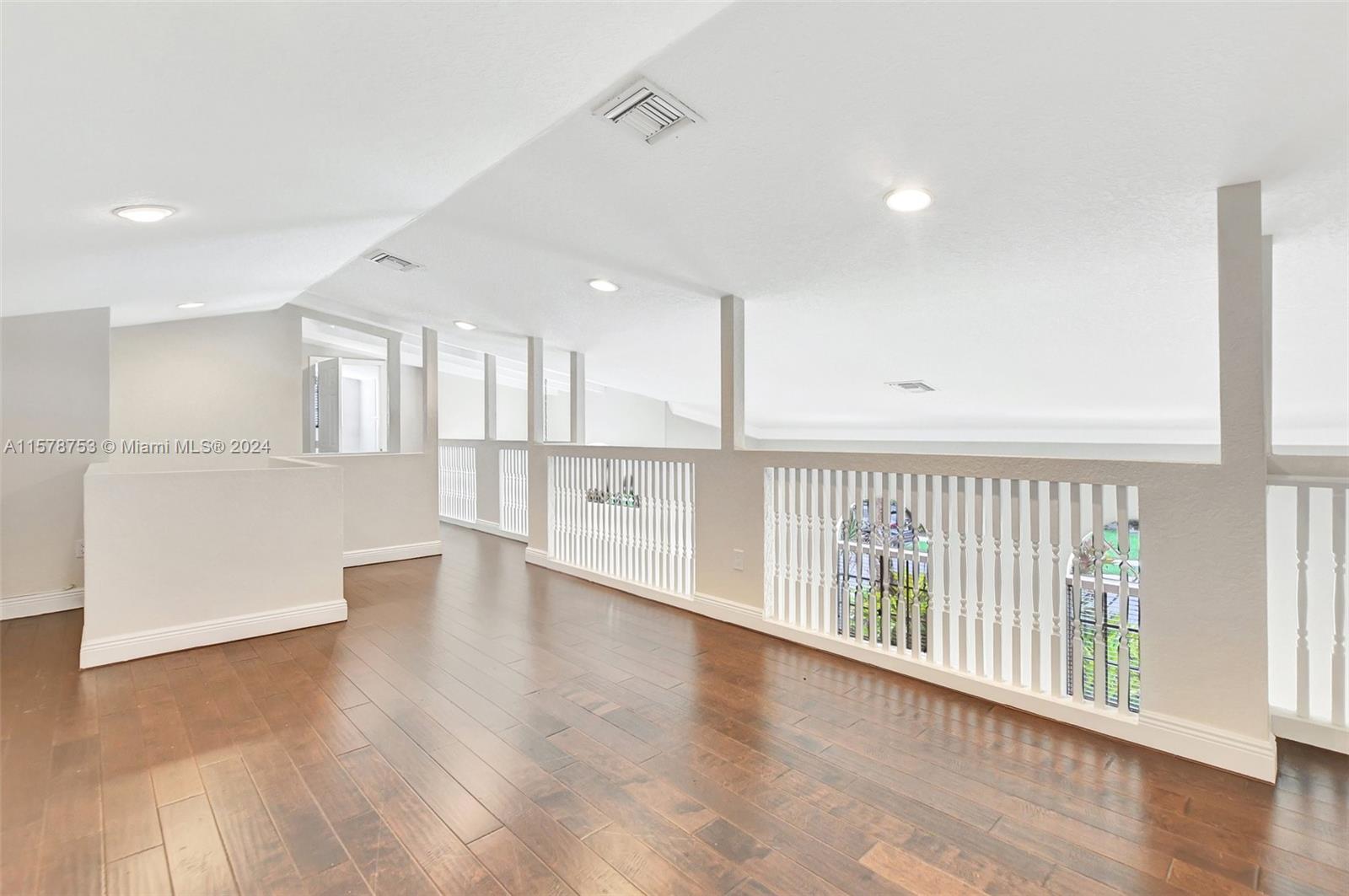 20916 Avenel Run Boca Raton, FL 33428 - Photo 30 of 43 a view of an empty room with wooden floor and a window