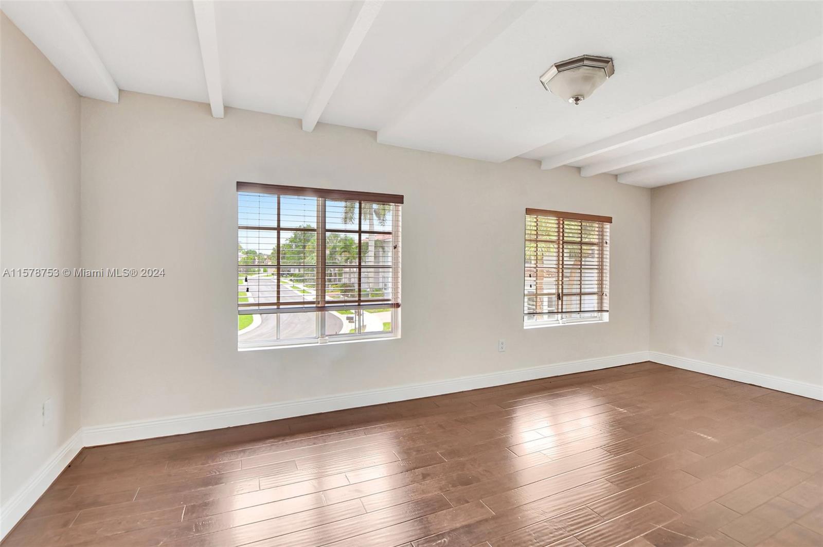 20916 Avenel Run Boca Raton, FL 33428 - Photo 31 of 43 a view of an empty room with wooden floor and a window