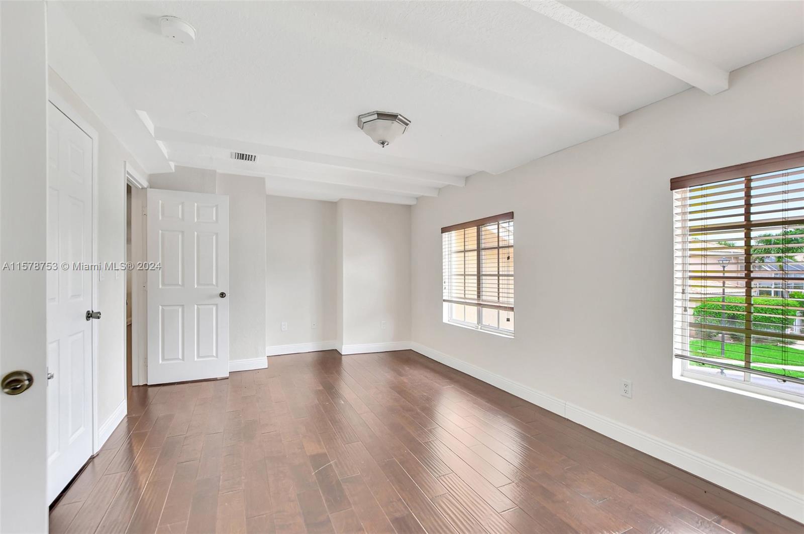 20916 Avenel Run Boca Raton, FL 33428 - Photo 33 of 43 a view of an empty room with wooden floor and a window