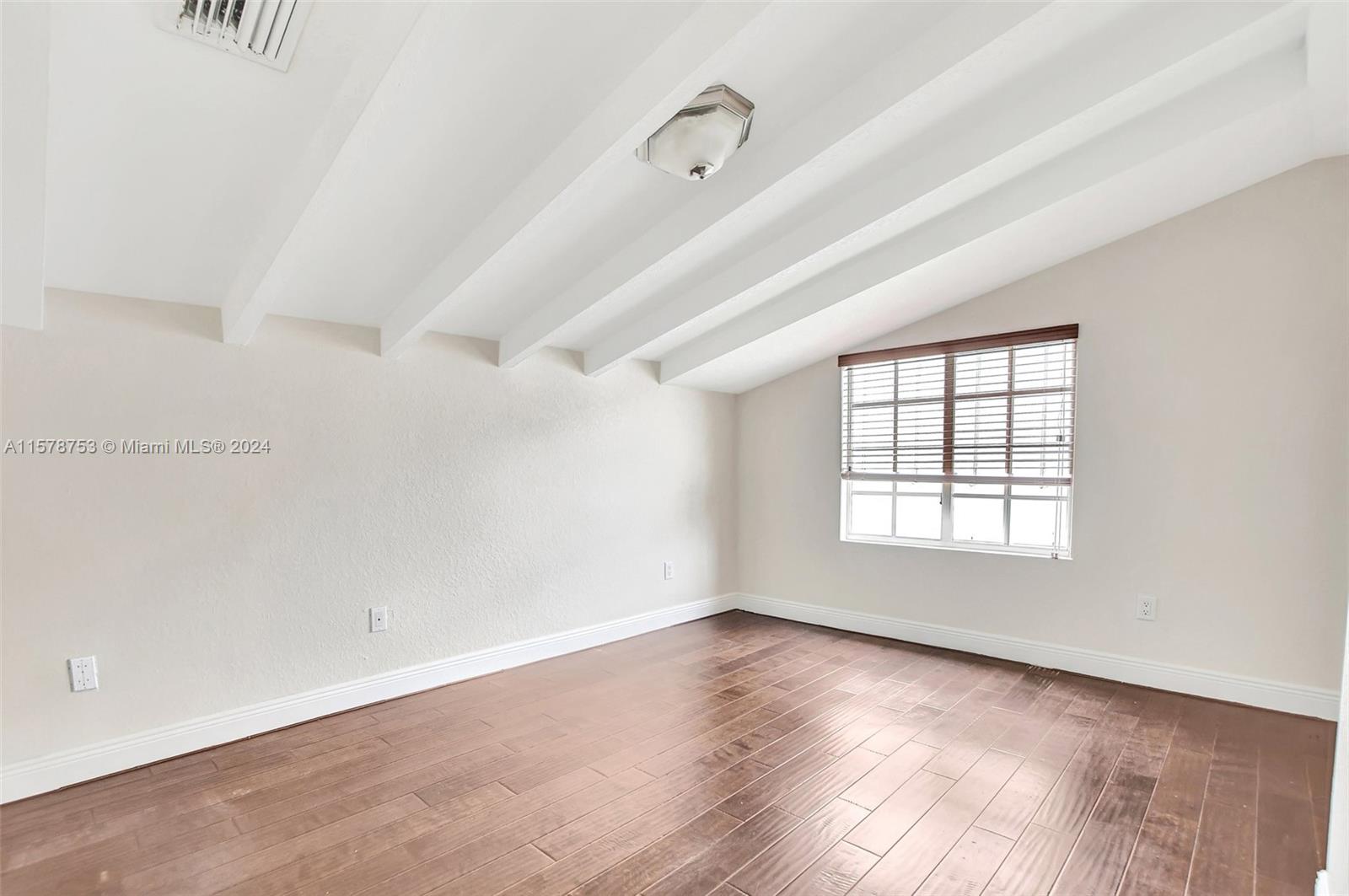 20916 Avenel Run Boca Raton, FL 33428 - Photo 35 of 43 an empty room with wooden floor and windows