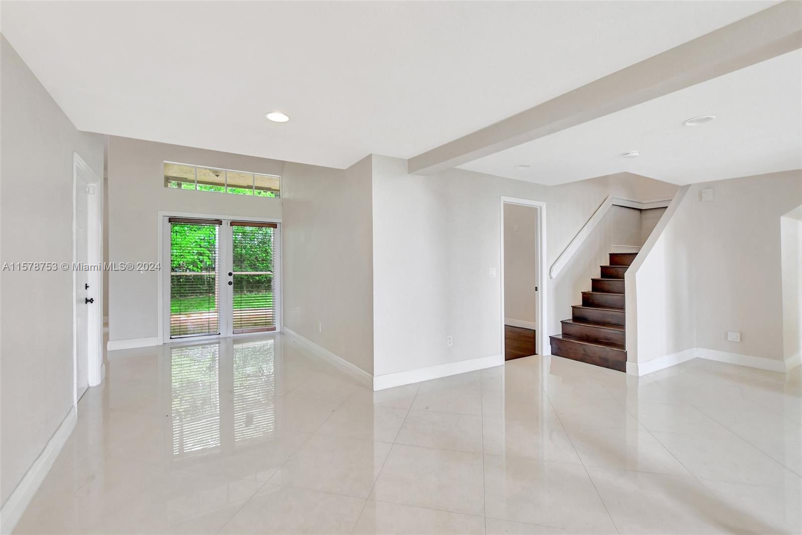 20916 Avenel Run Boca Raton, FL 33428 - Photo 10 of 43 a view of an empty room with wooden floor and stairs
