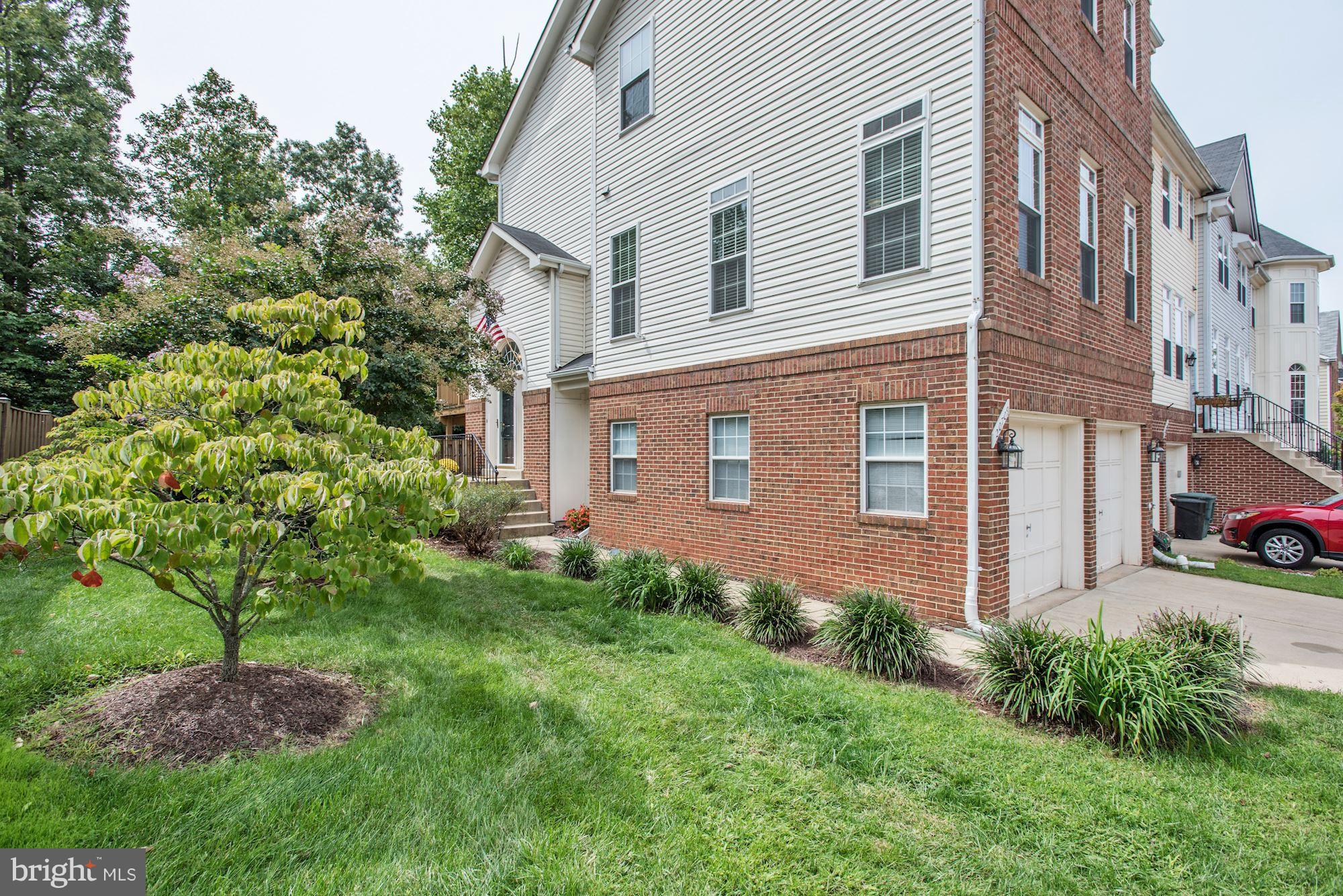 20709 Riptide Square Sterling, VA 20165 - Photo 2 of 30 a brick building with a yard in front of it