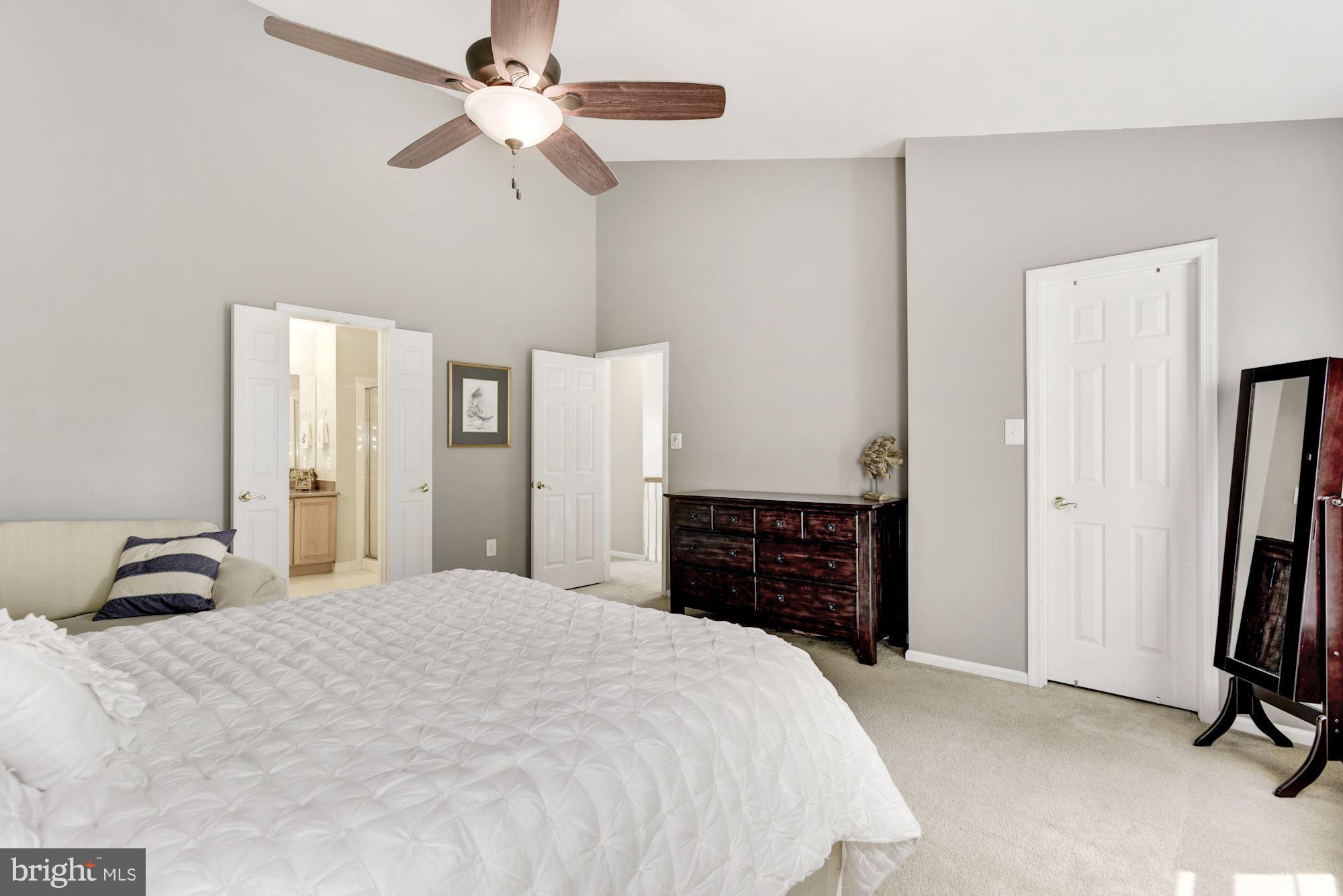 20709 Riptide Square Sterling, VA 20165 - Photo 17 of 30 a bedroom with a bed and a chandelier