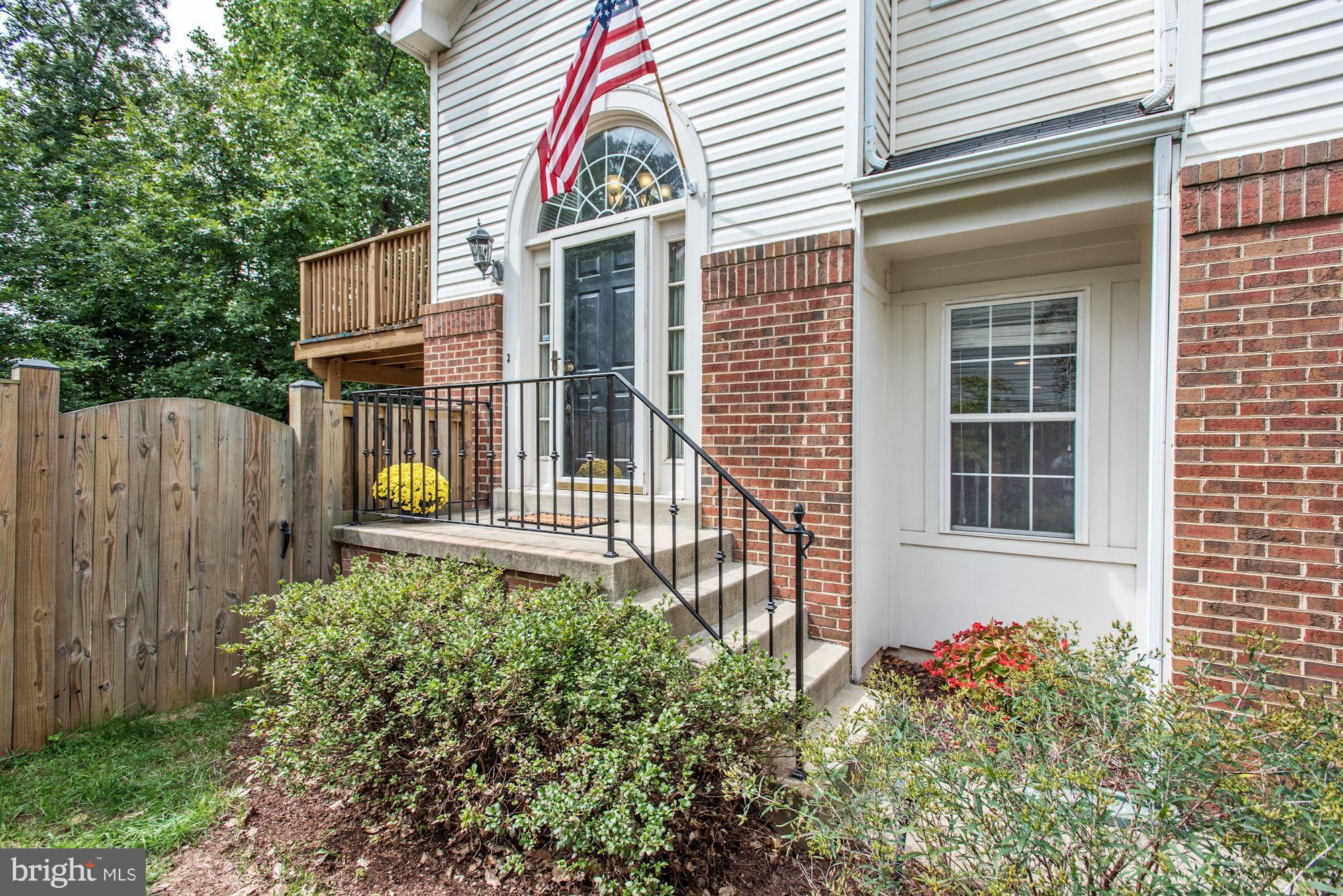 20709 Riptide Square Sterling, VA 20165 - Photo 3 of 30 a front view of a house with a yard and balcony
