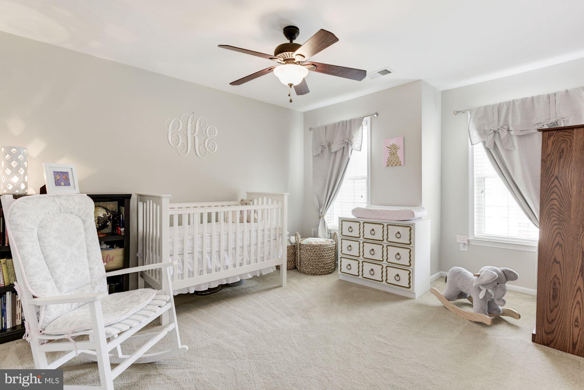 20709 Riptide Square Sterling, VA 20165 - Photo 22 of 30 a bedroom with furniture and a chandelier