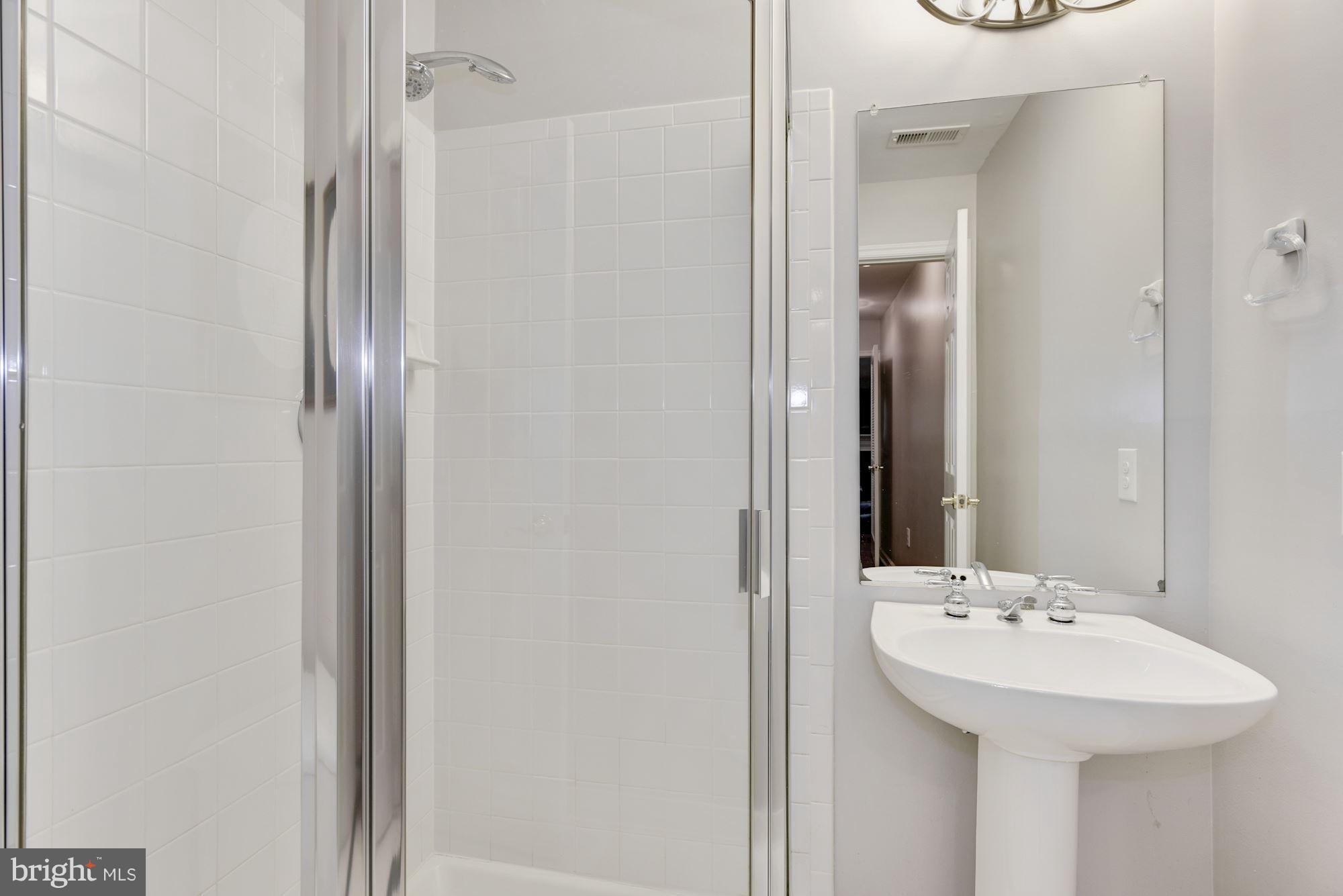 20709 Riptide Square Sterling, VA 20165 - Photo 29 of 30 a bathroom with a sink and a mirror
