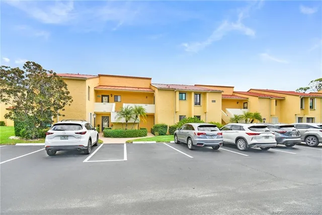 a view of cars parked in front of a house