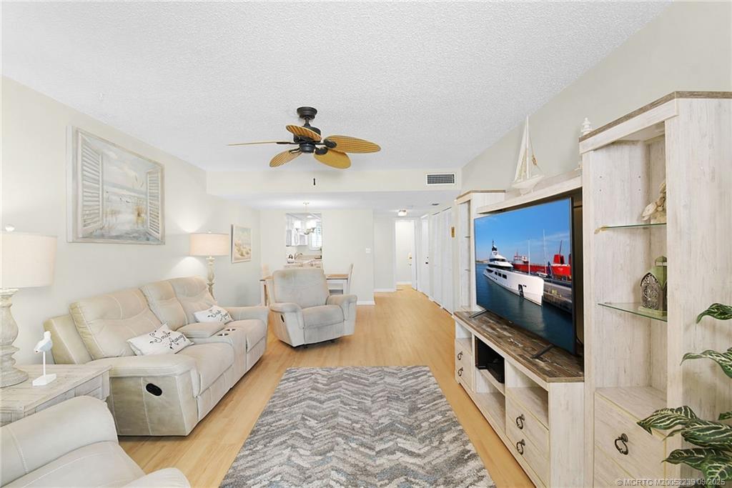 5313 Southeast Miles Grant Road, Unit 102 Stuart, FL 34997 - Photo 14 of 48 a living room with furniture and a flat screen tv