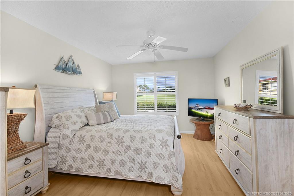 5313 Southeast Miles Grant Road, Unit 102 Stuart, FL 34997 - Photo 18 of 48 a bedroom with a bed and a dresser