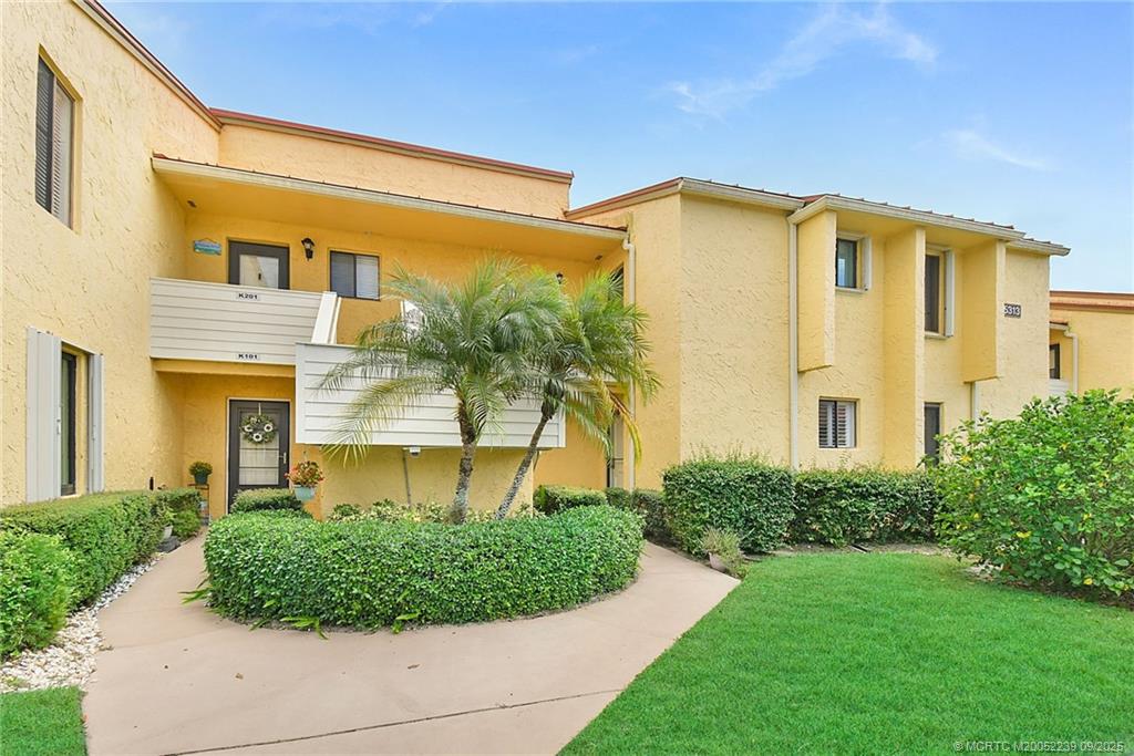 5313 Southeast Miles Grant Road, Unit 102 Stuart, FL 34997 - Photo 2 of 48 a house view with a garden space