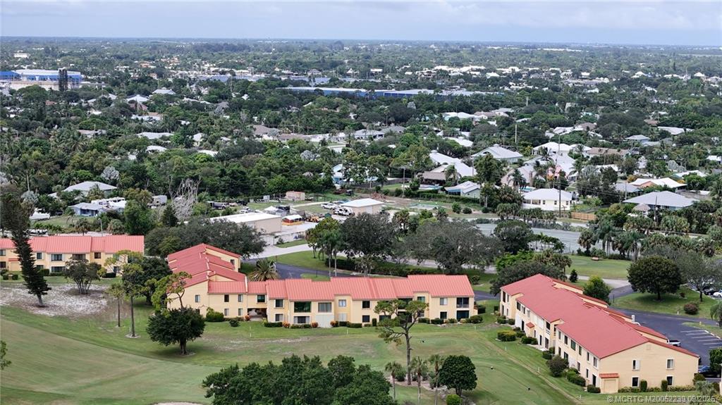 5313 Southeast Miles Grant Road, Unit 102 Stuart, FL 34997 - Photo 38 of 48 an aerial view of a city with lots of residential buildings