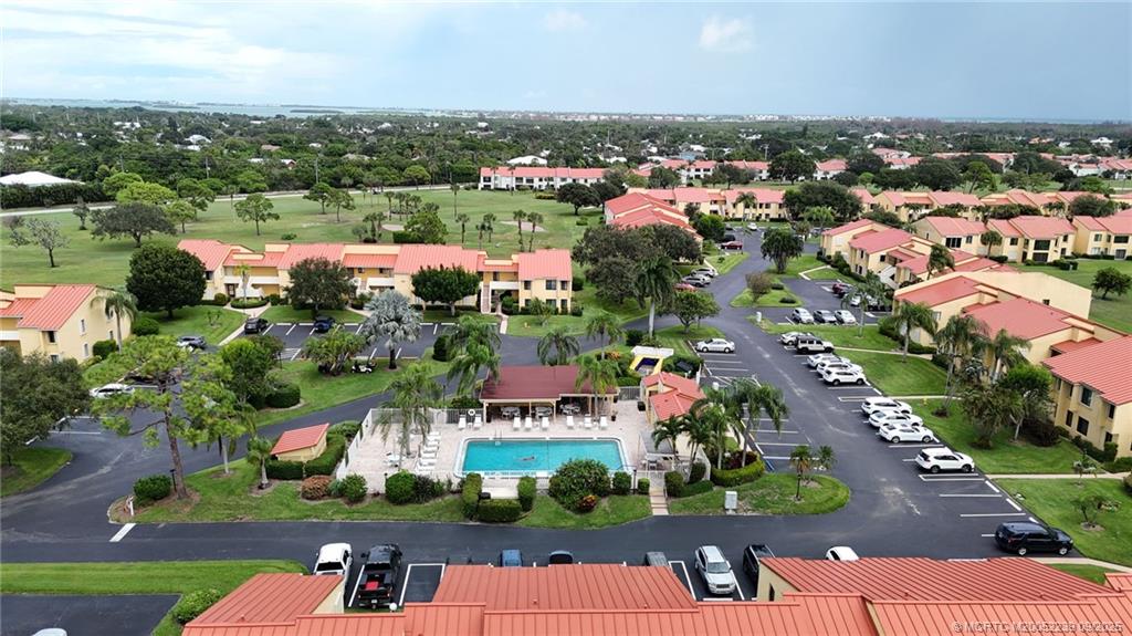 5313 Southeast Miles Grant Road, Unit 102 Stuart, FL 34997 - Photo 41 of 48 an aerial view of a city with lots of residential buildings ocean and mountain view in back