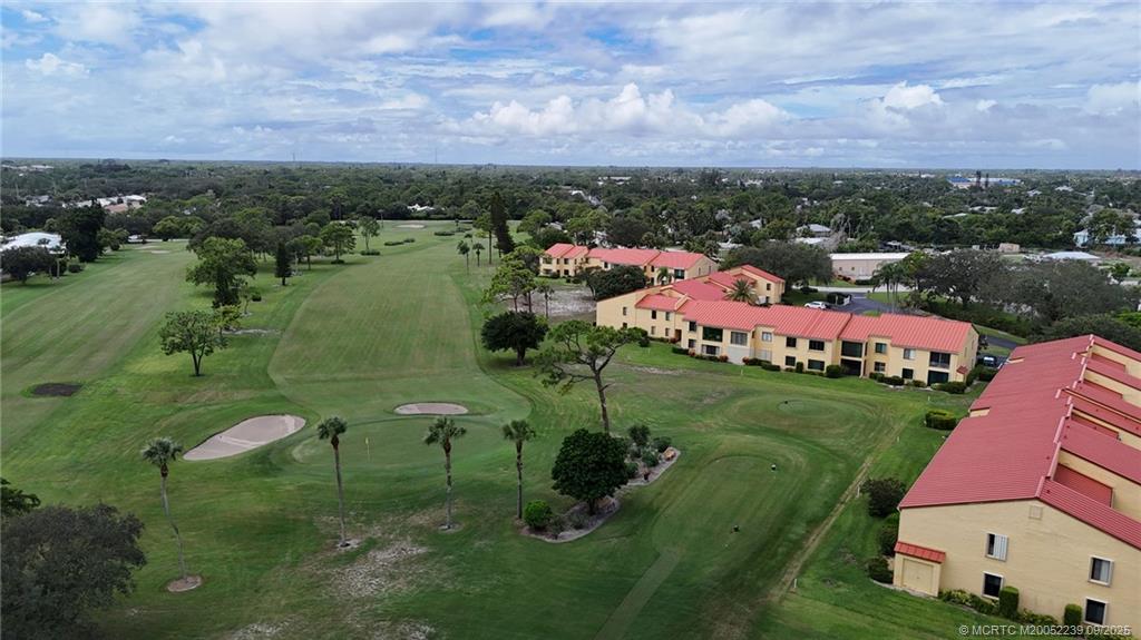 5313 Southeast Miles Grant Road, Unit 102 Stuart, FL 34997 - Photo 42 of 48 aerial view of a house with a yard and lake view