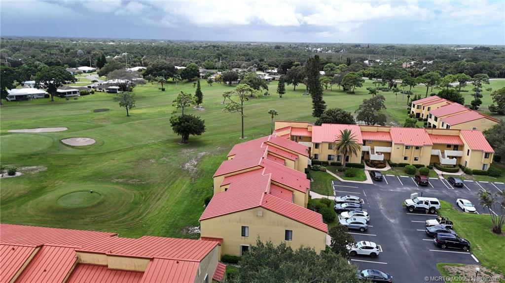 5313 Southeast Miles Grant Road, Unit 102 Stuart, FL 34997 - Photo 44 of 48 an aerial view of multiple houses with yard