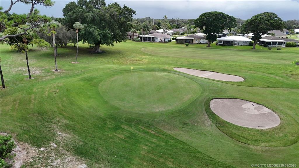 5313 Southeast Miles Grant Road, Unit 102 Stuart, FL 34997 - Photo 46 of 48 a view of a golf course with a trees