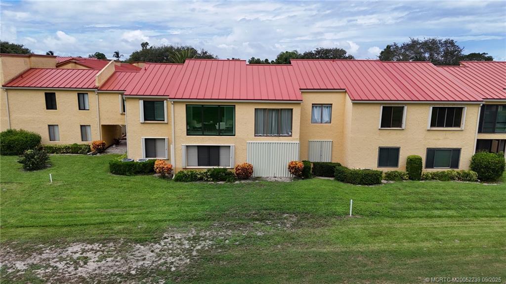 5313 Southeast Miles Grant Road, Unit 102 Stuart, FL 34997 - Photo 48 of 48 a view of a house with a garden