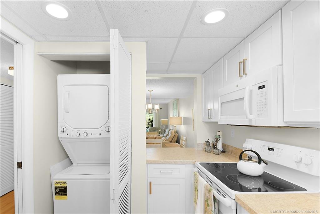 5313 Southeast Miles Grant Road, Unit 102 Stuart, FL 34997 - Photo 7 of 48 a kitchen with a sink a stove and cabinets