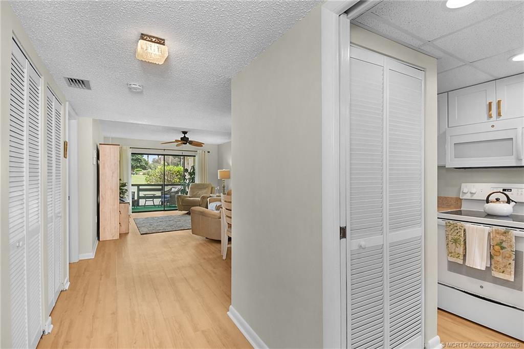 5313 Southeast Miles Grant Road, Unit 102 Stuart, FL 34997 - Photo 10 of 48 a view of a kitchen from the hallway
