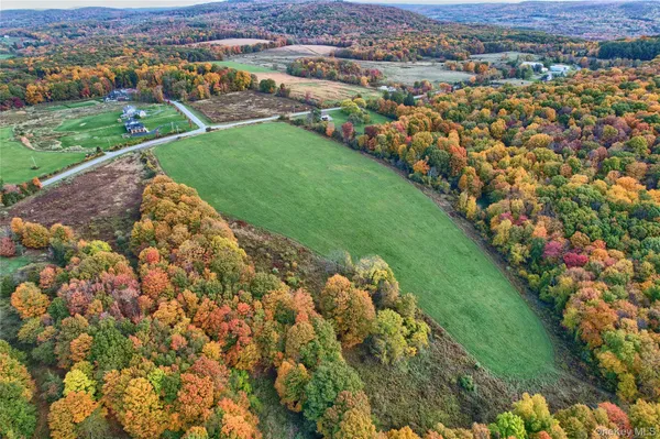 an aerial view of a houses with a yard