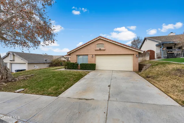 a view of garage yard and front view of a house