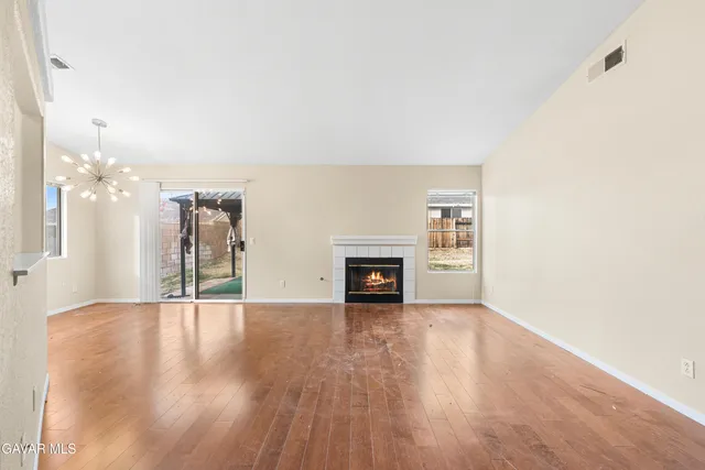 a view of an empty room with a fireplace