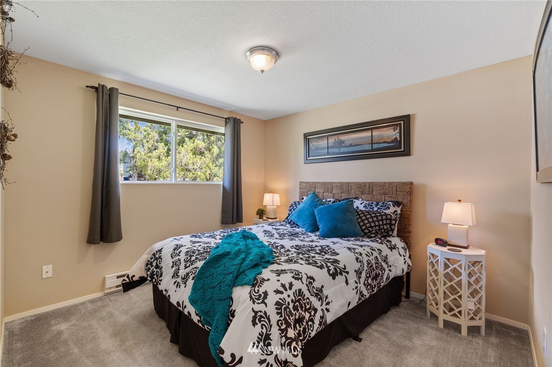 128 183rd Street Southwest Bothell, WA 98012 - Photo 12 of 33 a bedroom with a bed and a painting on the wall